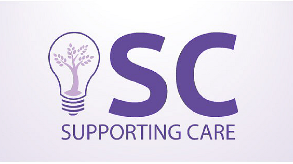 The SC Logo, there is purple text that says "SC" and below that text that says "Supporting Care". There is a lightbulb to the right of text that has a tree inside.