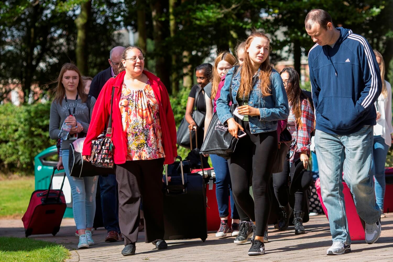 Year 12 Residential participants walk with their suitcases across campus as they prepare to move into a hall of residence at the start of the four-day event.