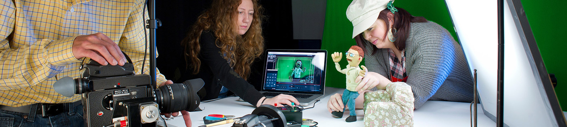 Animation students setting up a video of a clay model in the studio