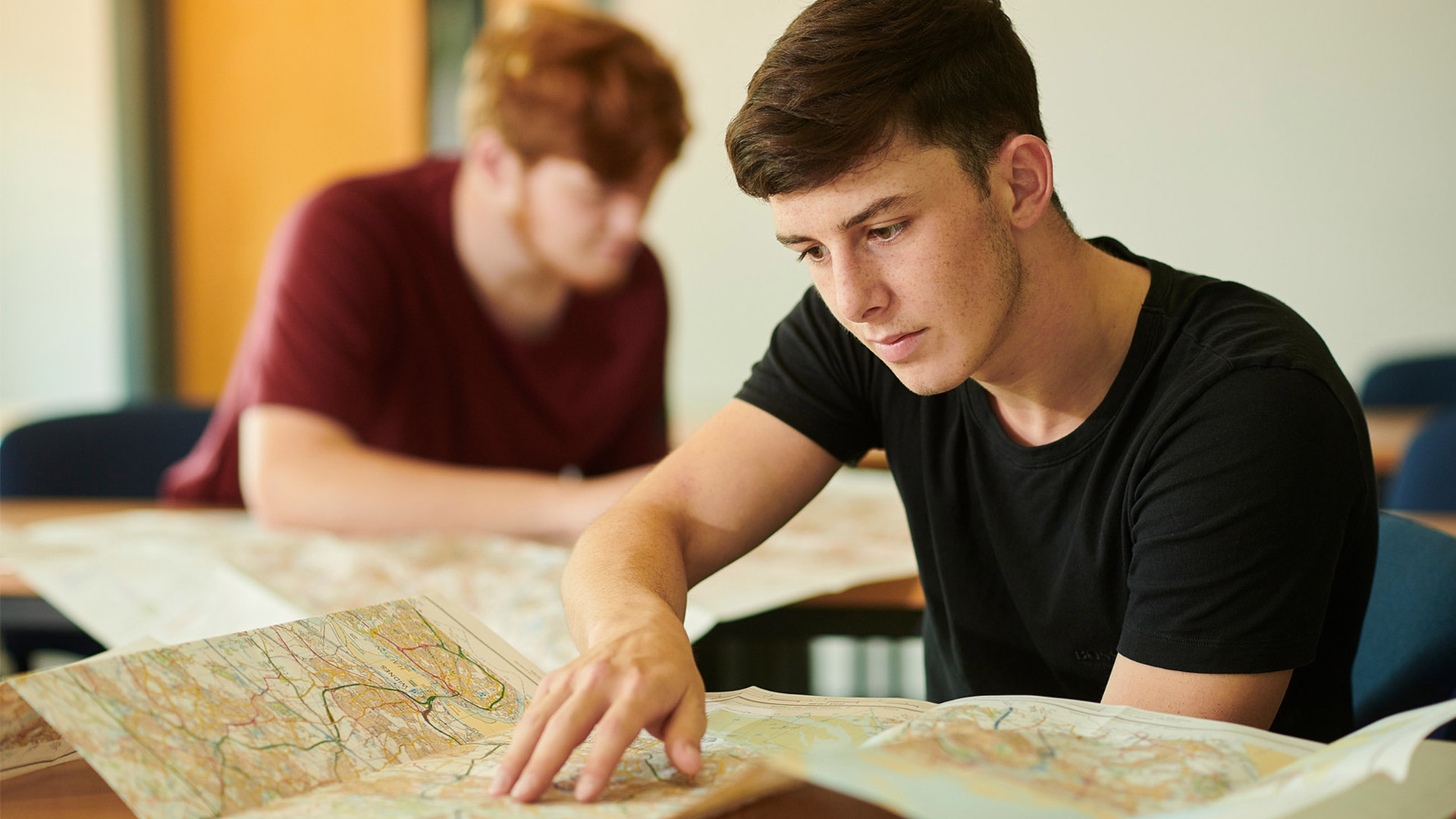 A geography student reads a map
