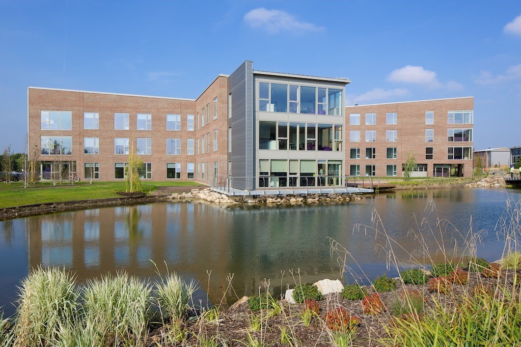 A lakeside view of the Chancellors' halls of residence.