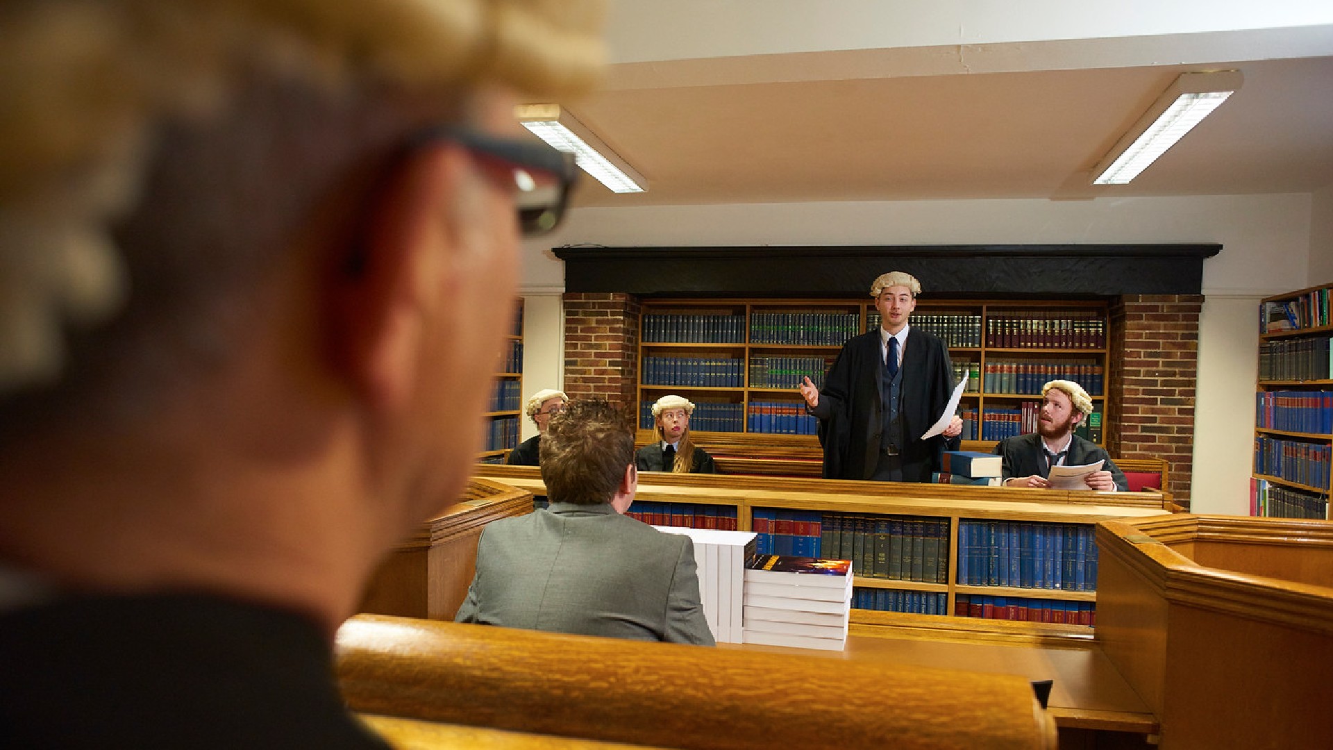 An image of law students practicing a moot in a set-up courtroom.