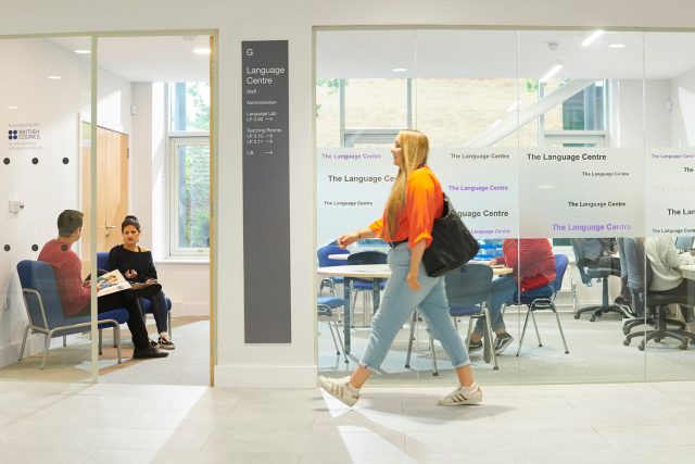 A student walks past a classroom in the Language Centre.