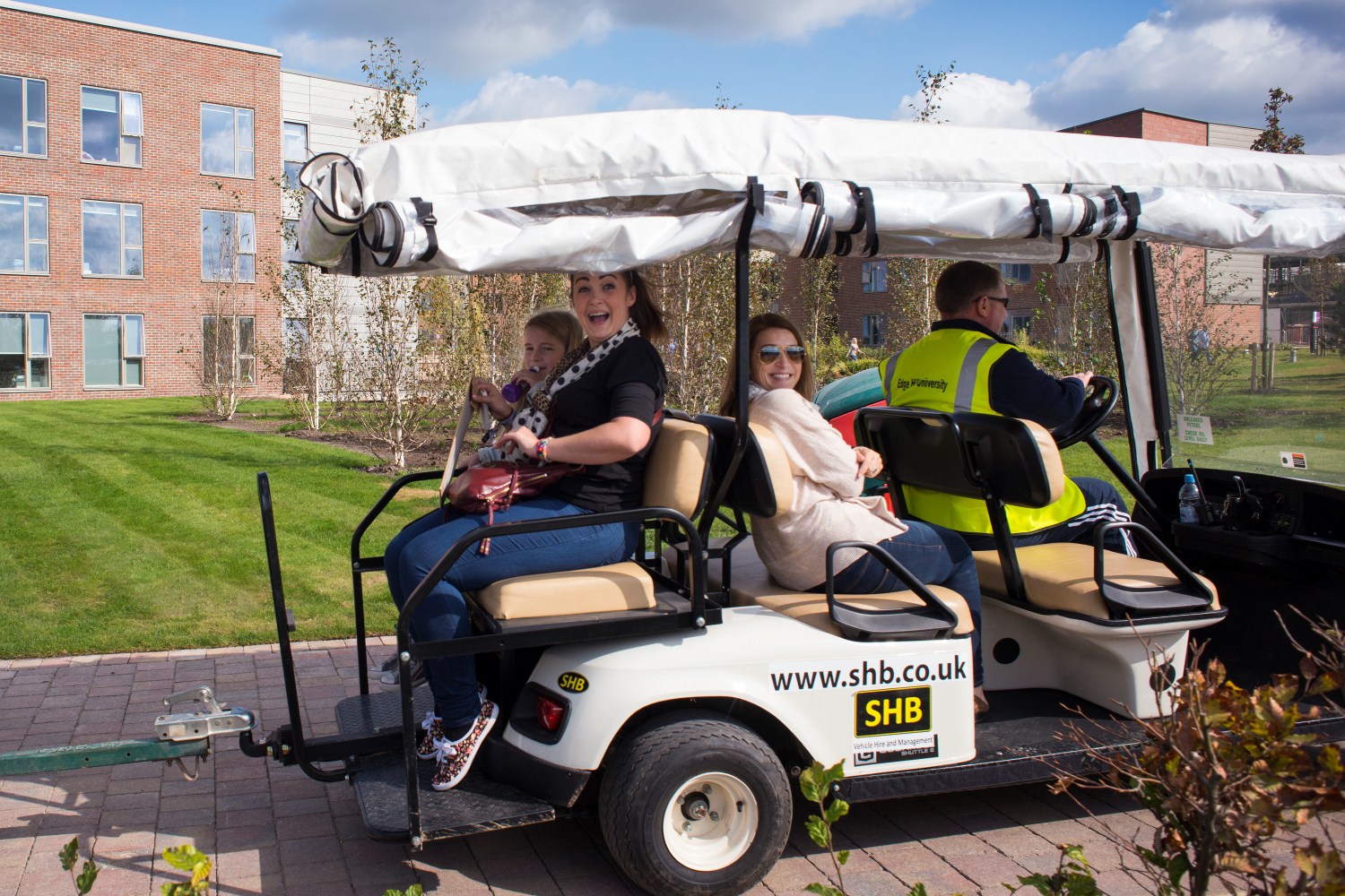 A student and her family take a buggy ride on campus.