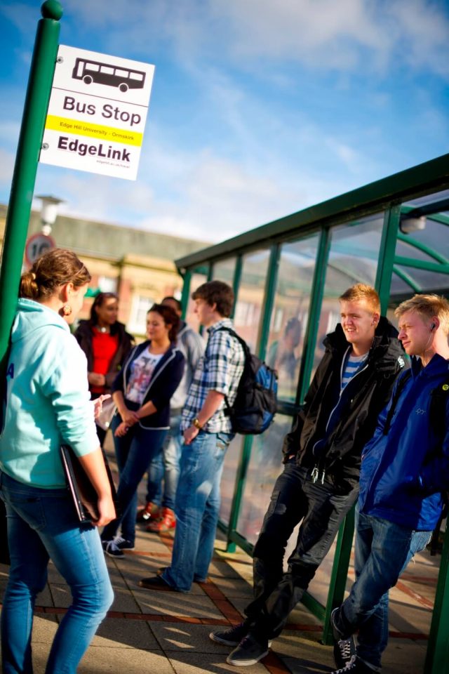 Students wait at the bus stop on campus for the Edge Link shuttle bus to Ormskirk.
