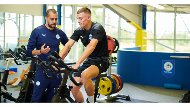 Rik Southworth helping a club member with training on exercise bike