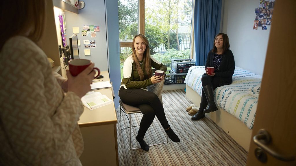 An image of three people in an accomodation room at Edge Hill University.