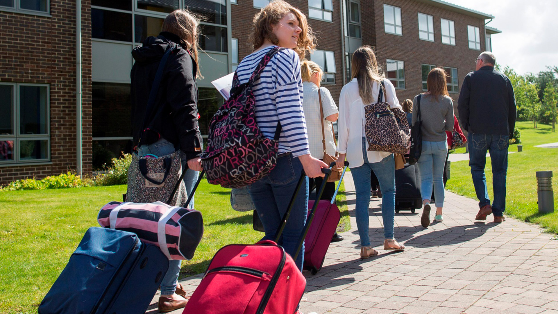 A group of students arriving at halls with their luggage