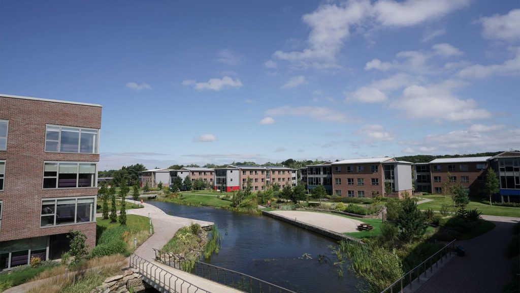 An aerial shot of part of the Edge Hill University campus, overlooking one of the lakes running through the campus and a section of the accomodation buildings.