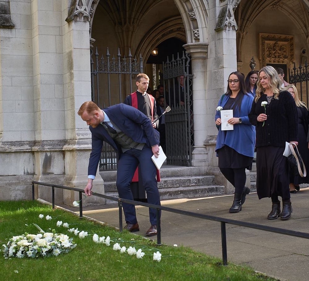 Travis Frain lays flowers at the commemoration of the Westminster terror attack