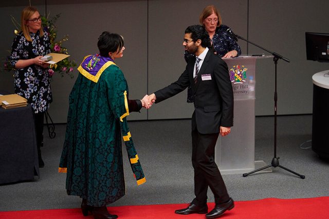 Adam Bell Scholarship winner Husnain Shah shakes the hand of Tanya Byron at a Scholarship Awards Evening.