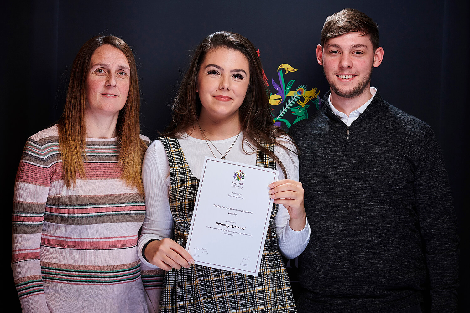 Excellence Scholarship winner Bethany Attwood, with her family, showing her certificate at a Scholarship Awards Evening.