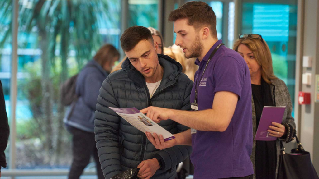 An image of a student advisor helping a prosepctive student on an open day. 
