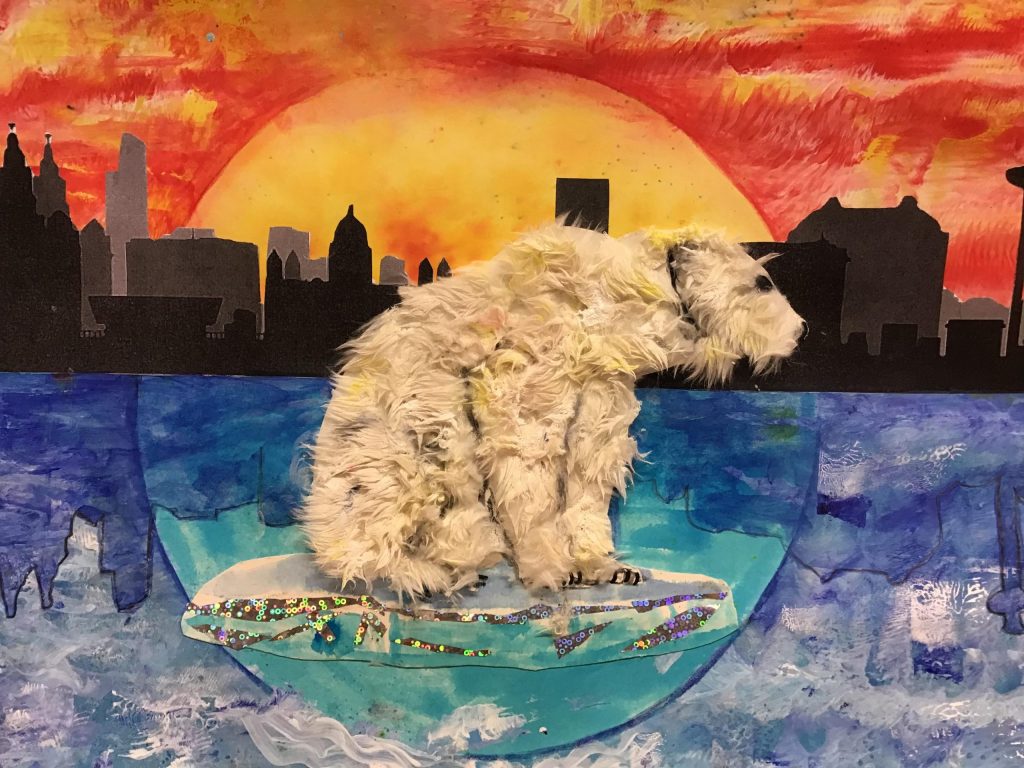 A polar bear collage sitting on an ice float.