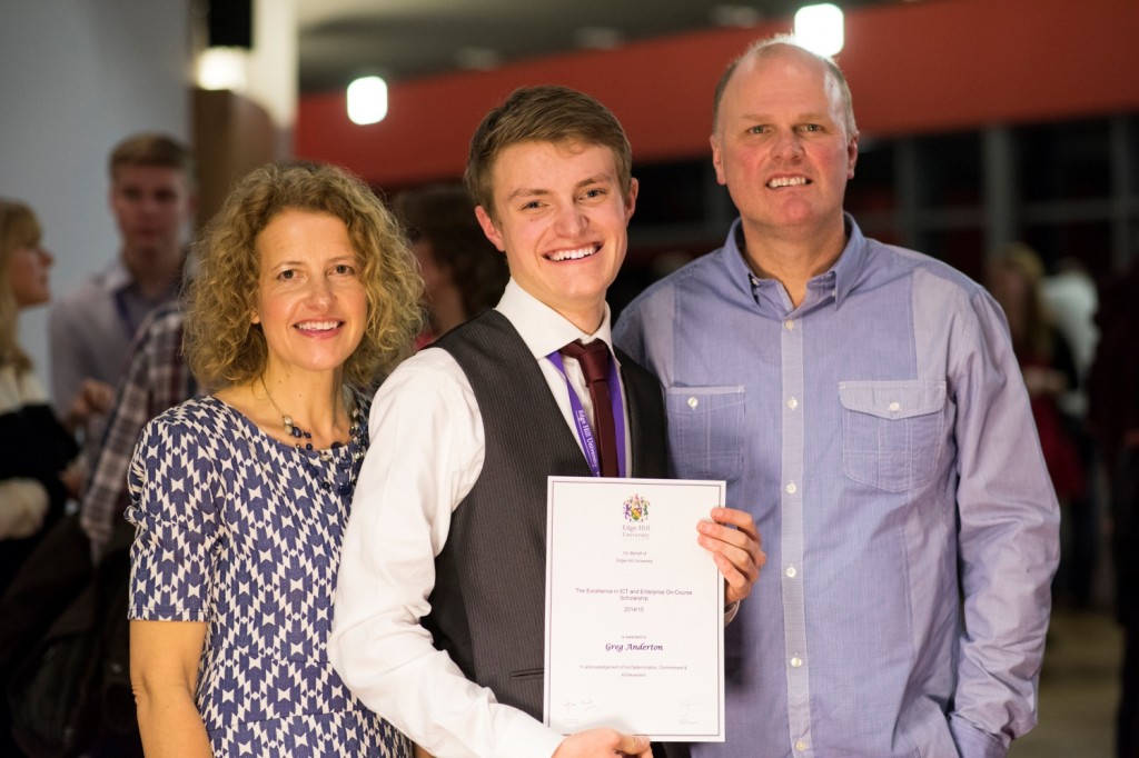 Student Greg Anderton, with his parents, showing his Excellence Scholarship Certificate at a Scholarship Awards Evening.
