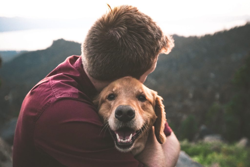 Man hugging a very happy looking dog