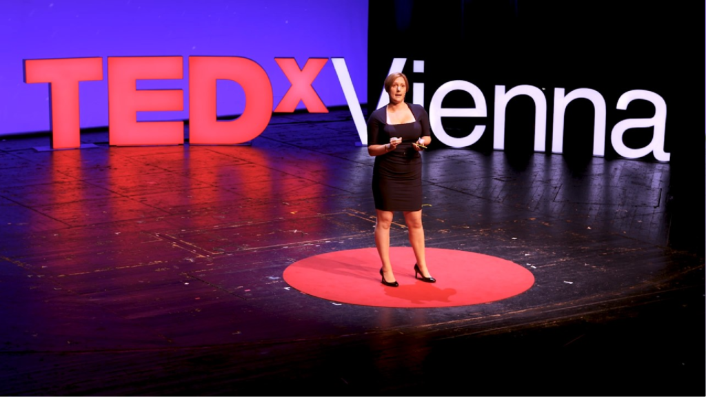 An image of Linda Kaye presenting a ted talk. 