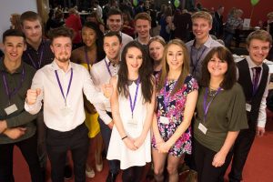 Scholarship winners pose for a group photo during a scholarship awards evening.