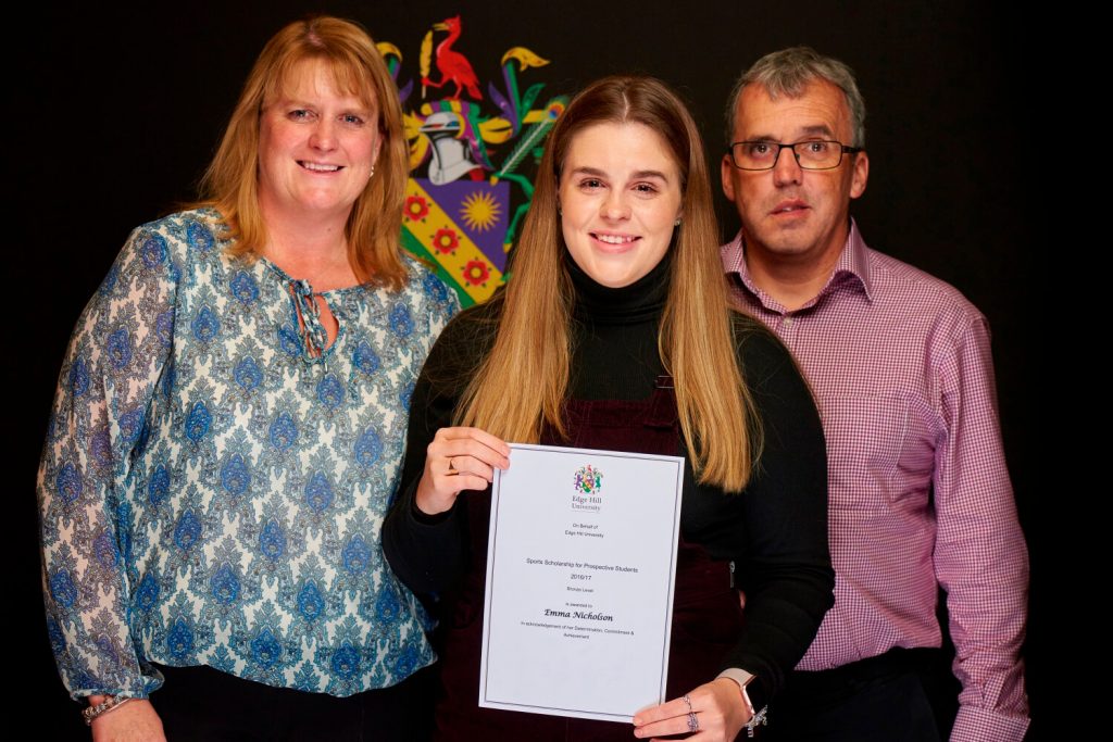 Sports Scholarship winner Emma Nicholson, with her family, showing her certificate at a Scholarship Awards Evening.