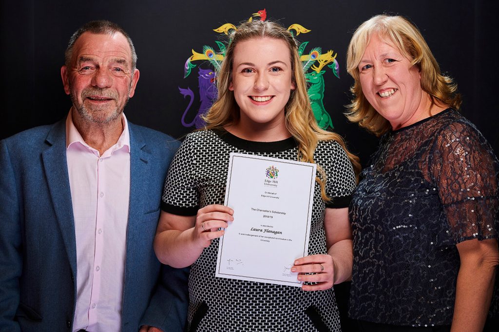 University Scholarship winner Laura Flanagan, with her parents, shows her certificate at a Scholarship Awards Evening.