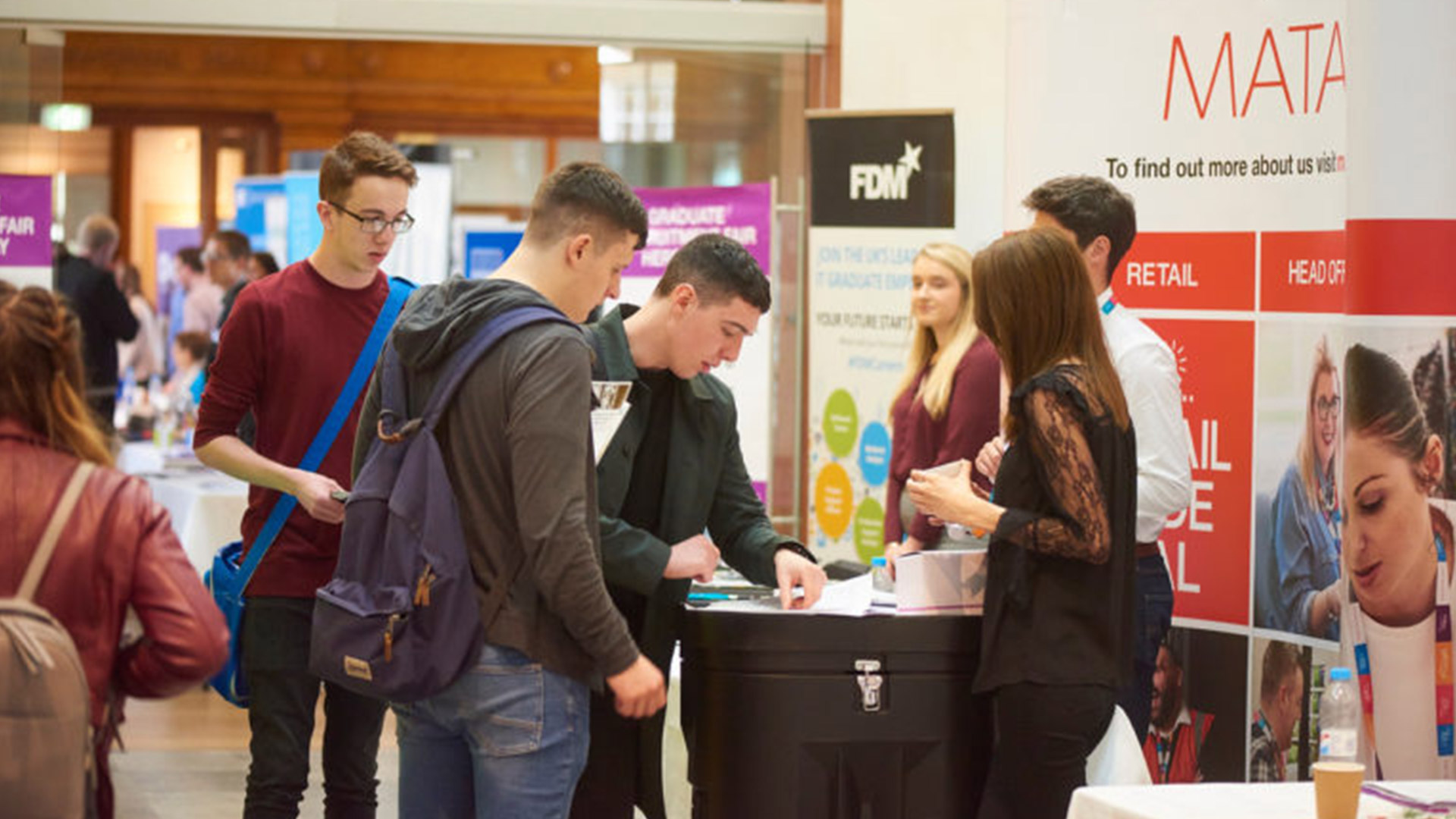 a group of students stood at a careers stand
