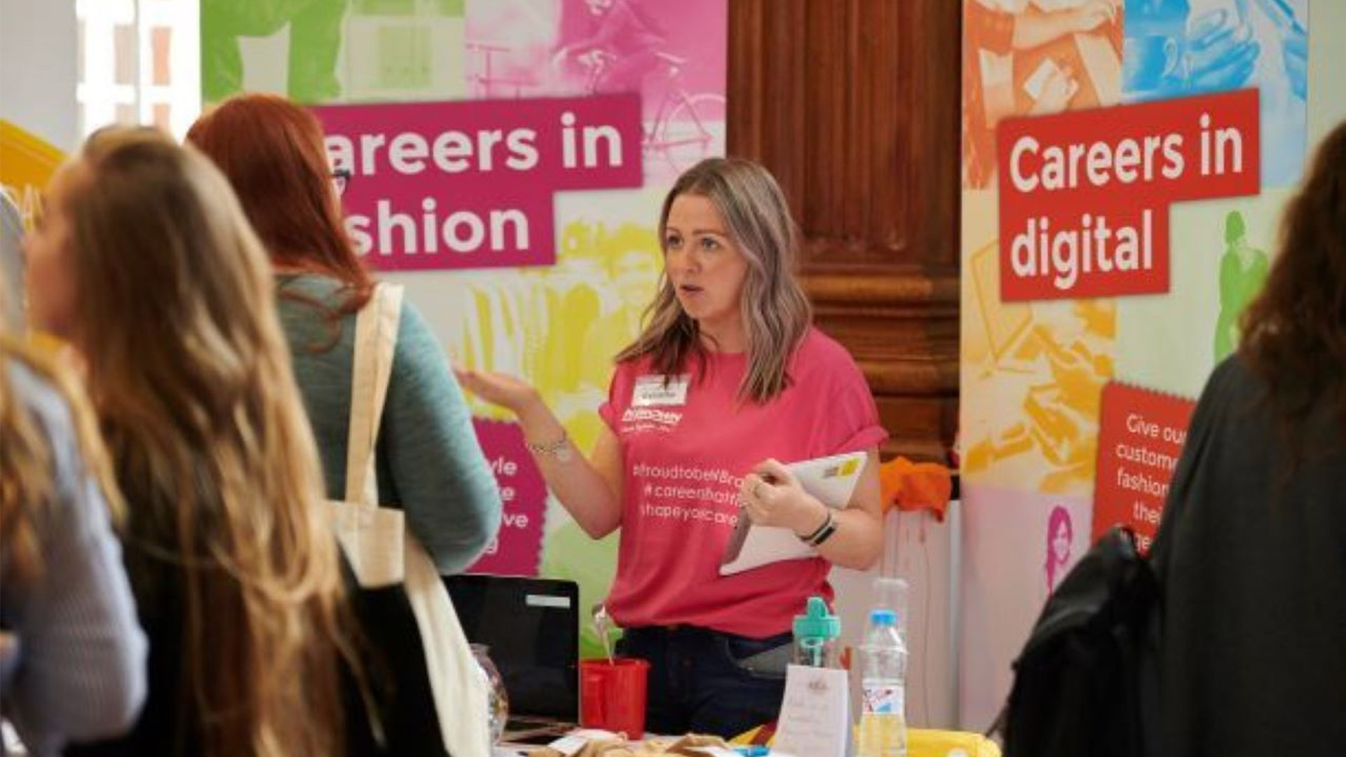an advisor helping someone at a careers stand