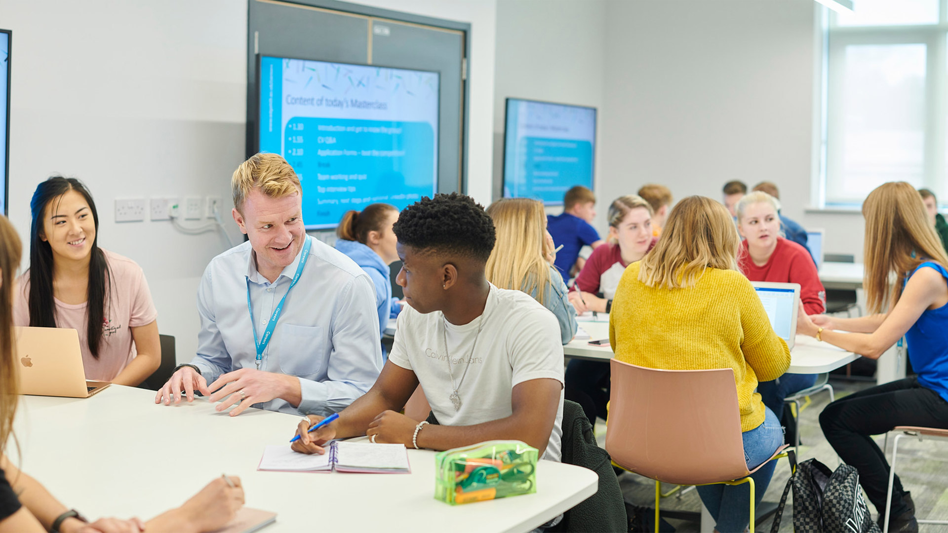 a group of students sit around a table with a careers advisor