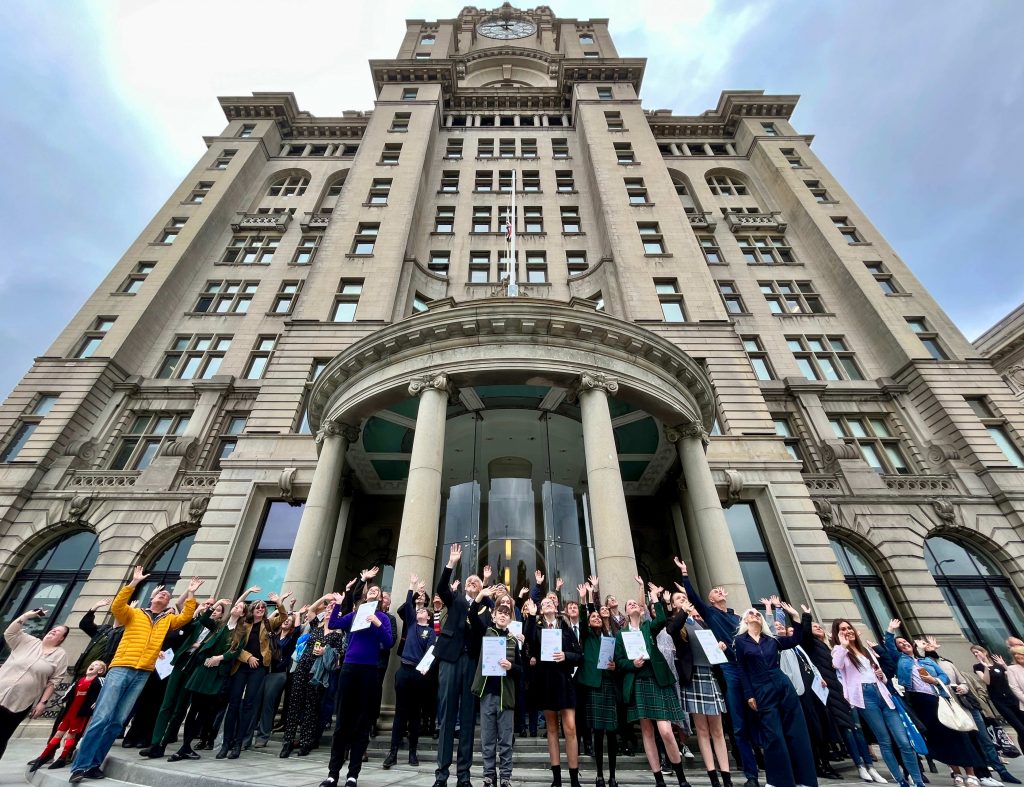School children and teachers standing outside the Liver building in Liverpool