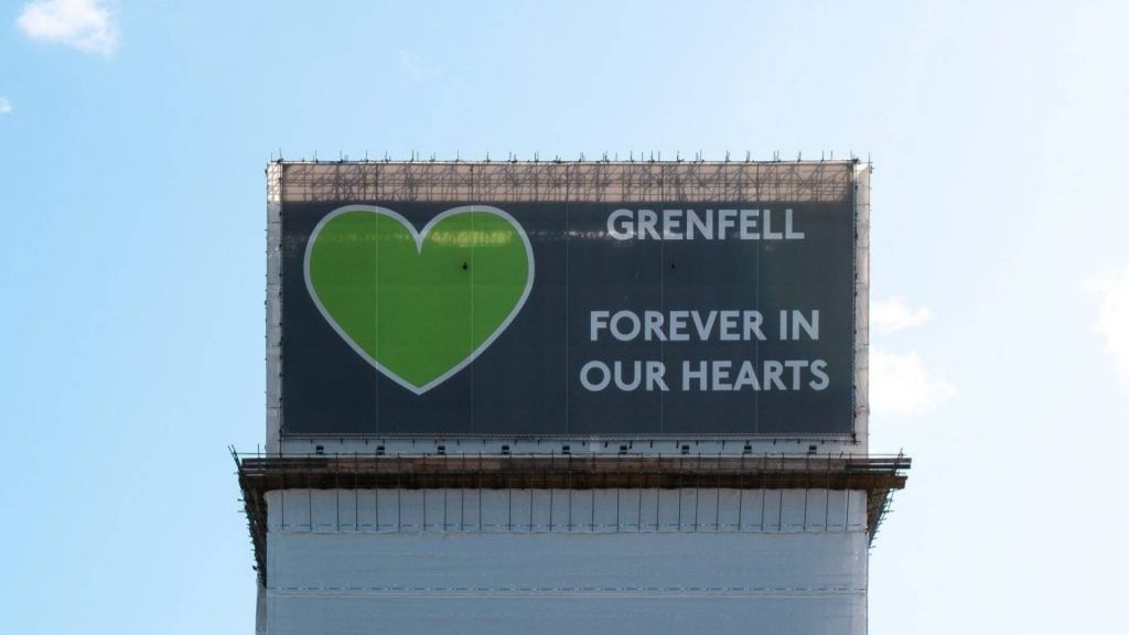 Banner over Grenfell block saying Grenfell forever in our hearts