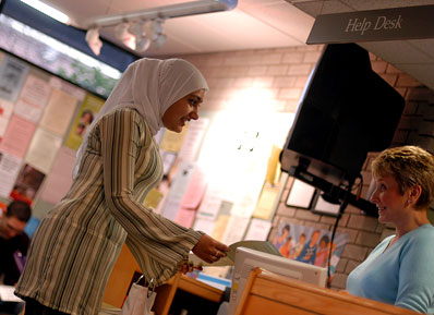 A student talks to a member of help desk staff