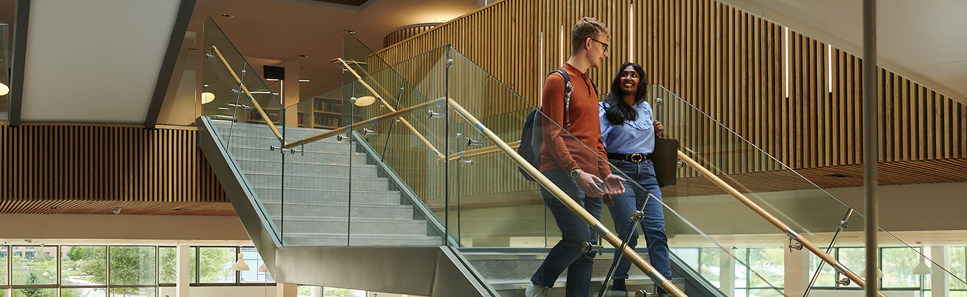 A pair of students descend the steps in our Catalyst building.