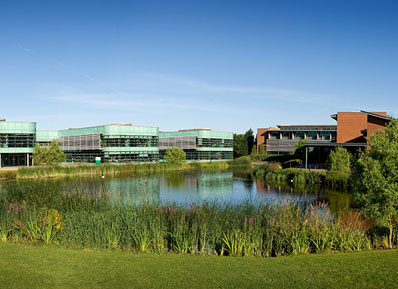 A view across the water on the west side of campus, with views of the Faculty of Education and Faculty of Health and Social Care