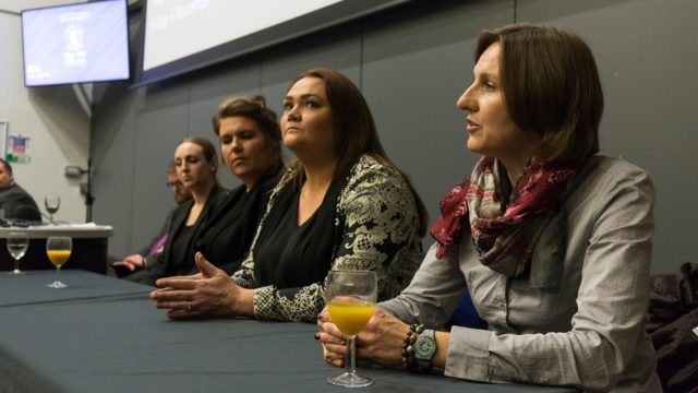 An image of five past law students talking on a panel. 