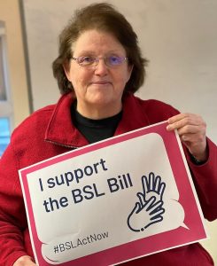 Picture of Labour MP Rosie Cooper holding a sign that states "I support the BSL (british sign language) Bill