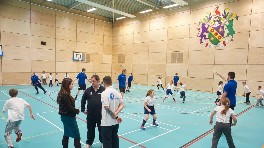 An image of a large group of people playing a game within the sports centre at Edge Hill