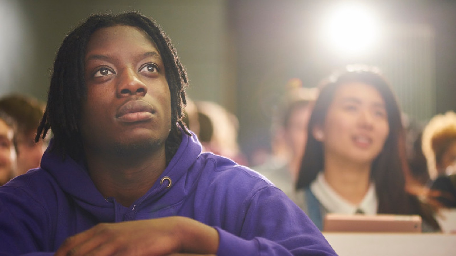 students in lecture theatre looking to front