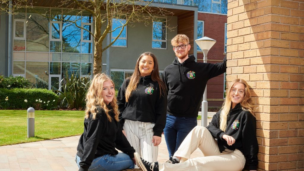 An image of a group of law students stood in front of the law building on the Edge Hill University campus.