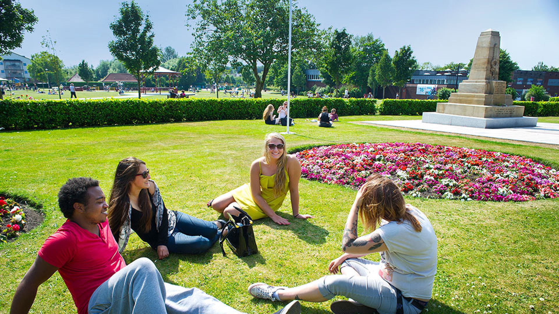 An image of a group of students sat on one of the parks within the Ormskirk town centre.