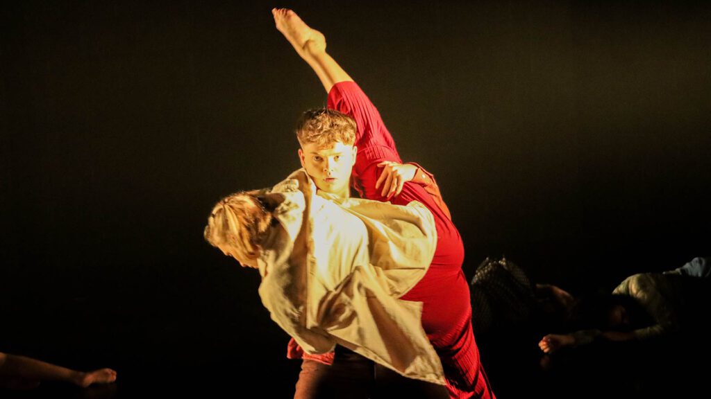Students dancing on a stage.