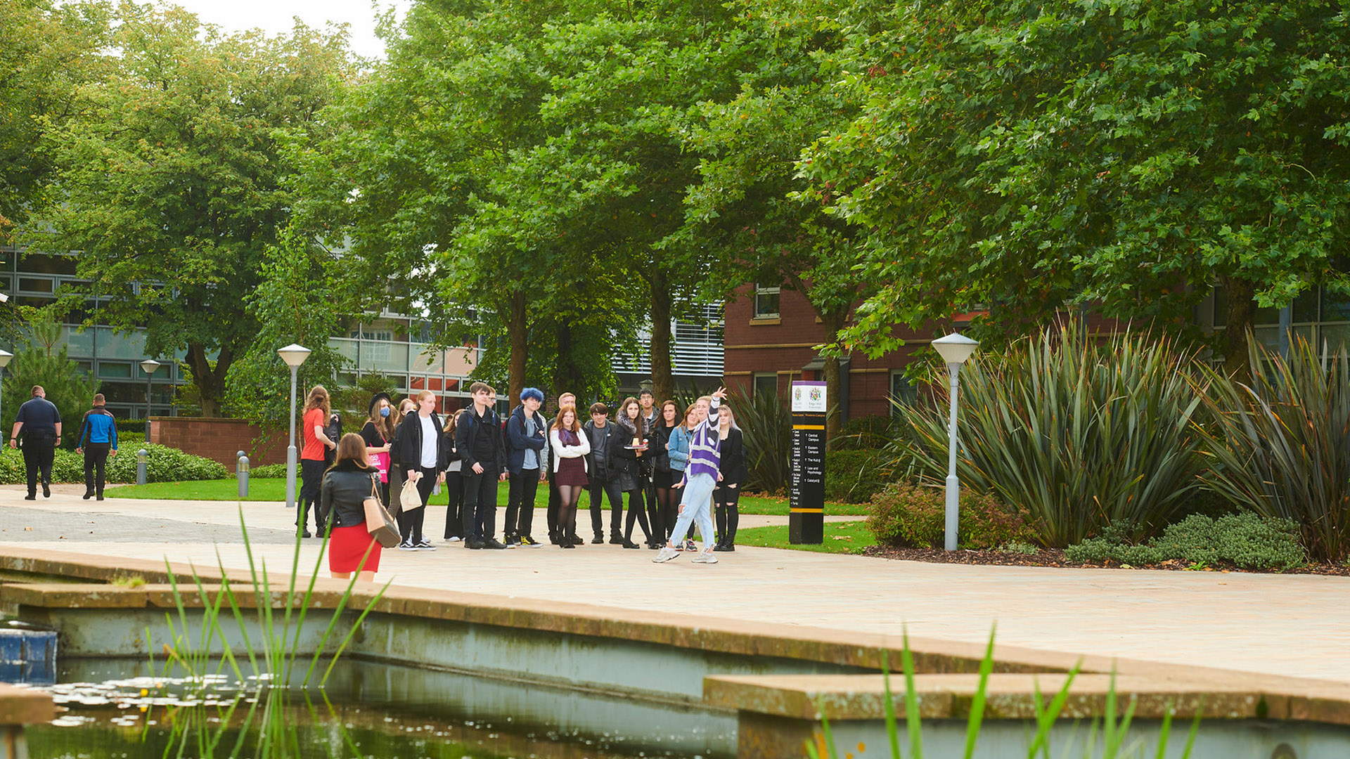 Young people walking on campus at a student recruitment event