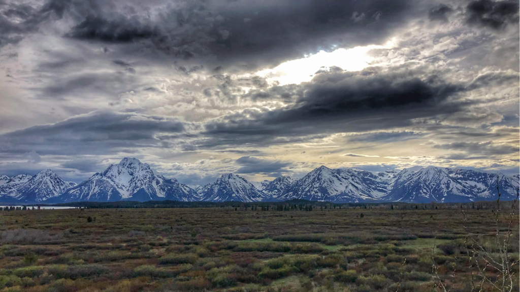 An image of clouds over the yellowstone national park. Mountains are visible in this image.