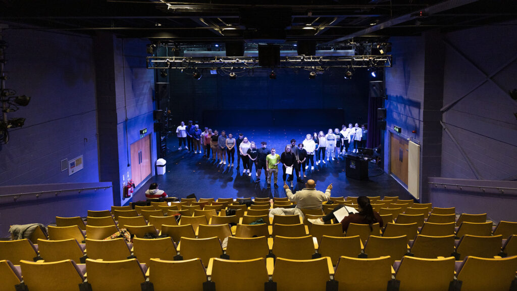 students audition in an empty theatre.