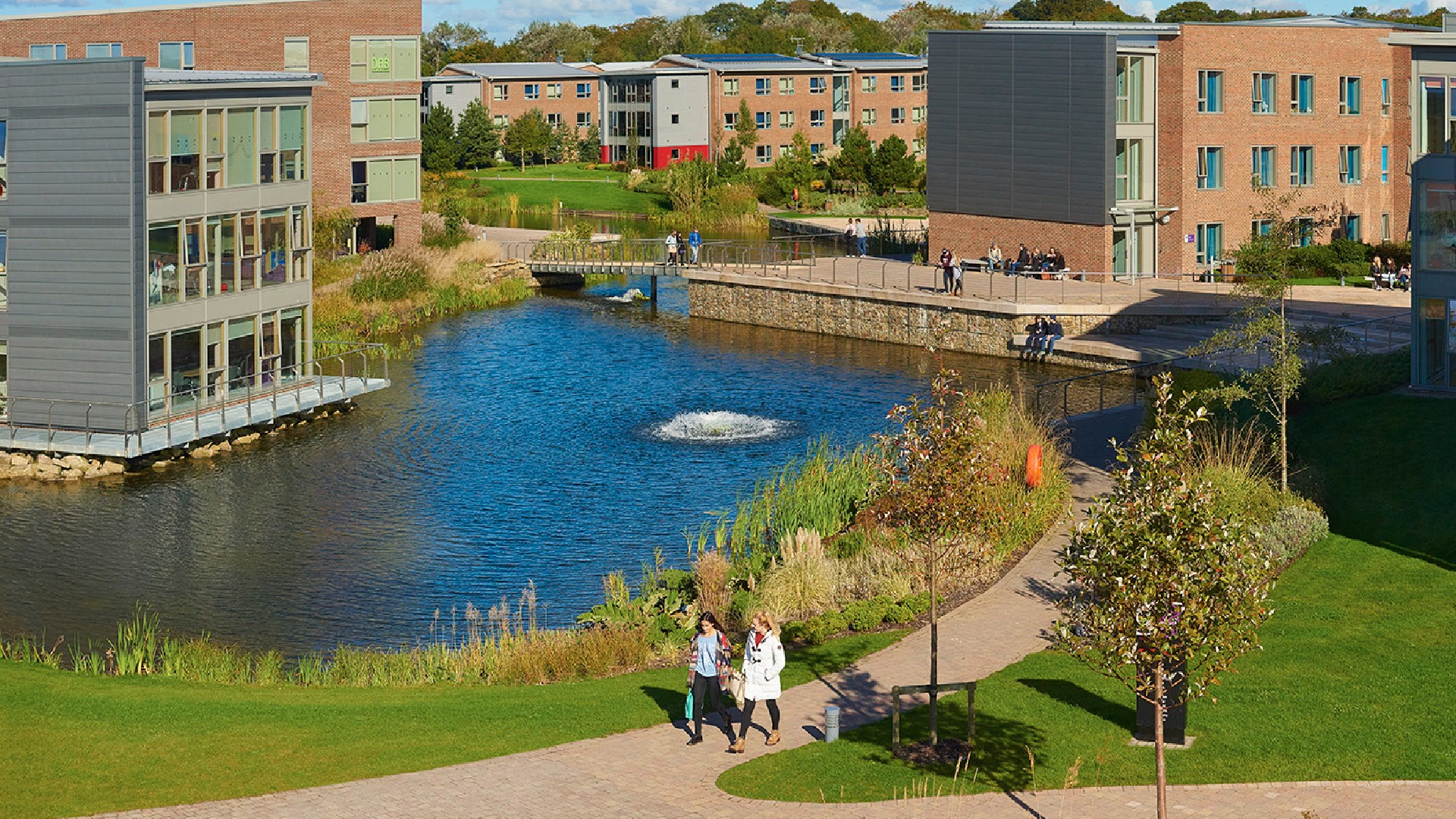 An image of a group of students outside various accomodation blocks on the Edge Hill University campus.