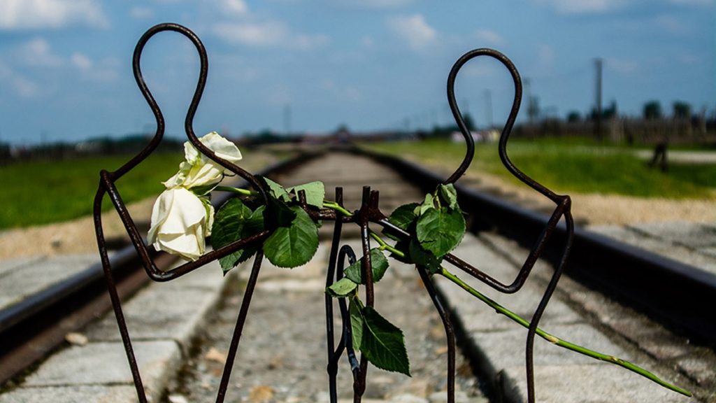 An image of a memorial at the end of the railway track at auschwitz.