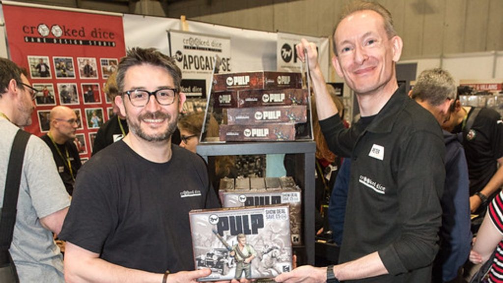 An image of Dr Peter Wright and Karl Perrotton, holding the "Pulp" boxed game.