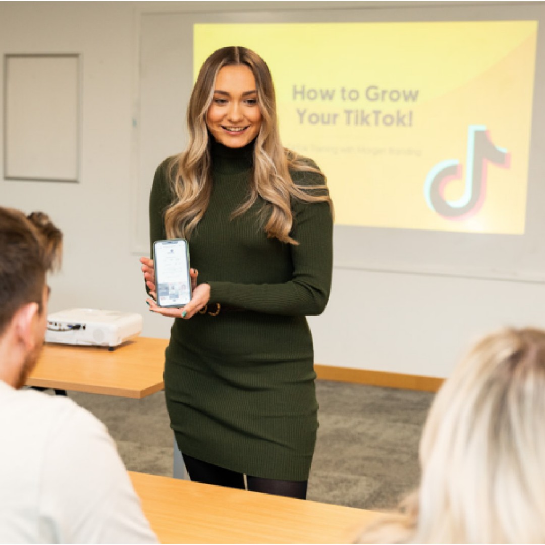 A student presenting to a panel an idea of how to grow your business on tiktok