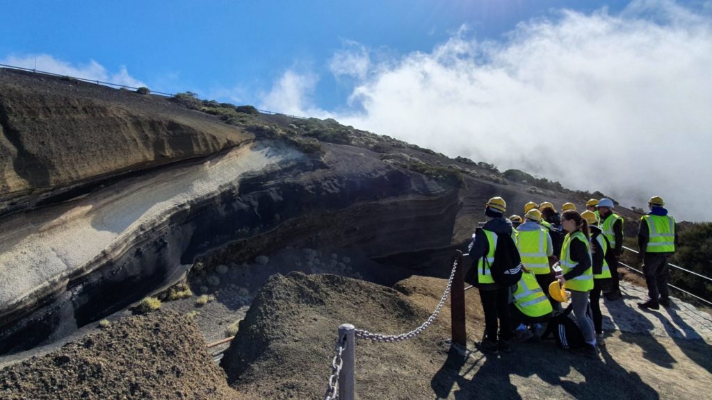 An image of a group of students stood looking at a volcano site.