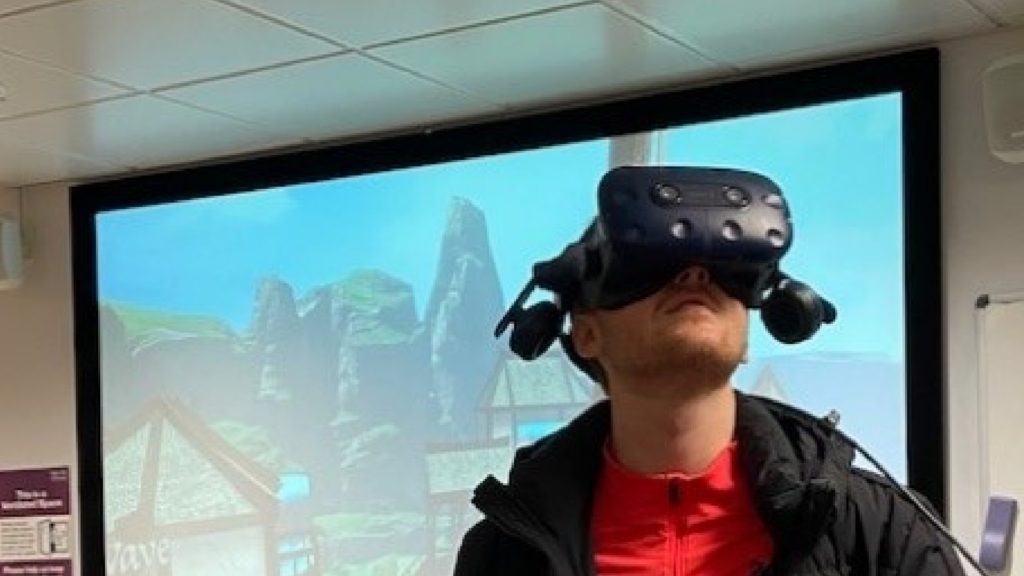 An image of a marketing student using a VR headset