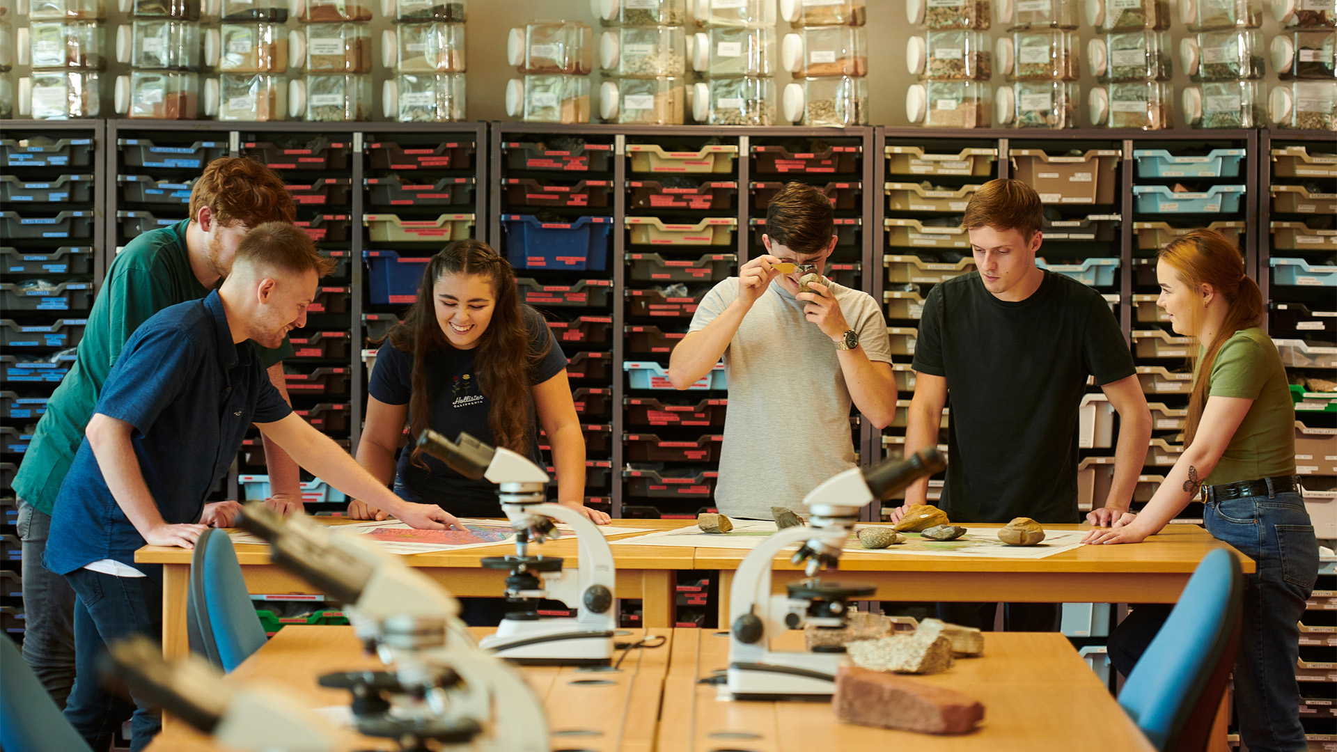 Six students examining rock samples