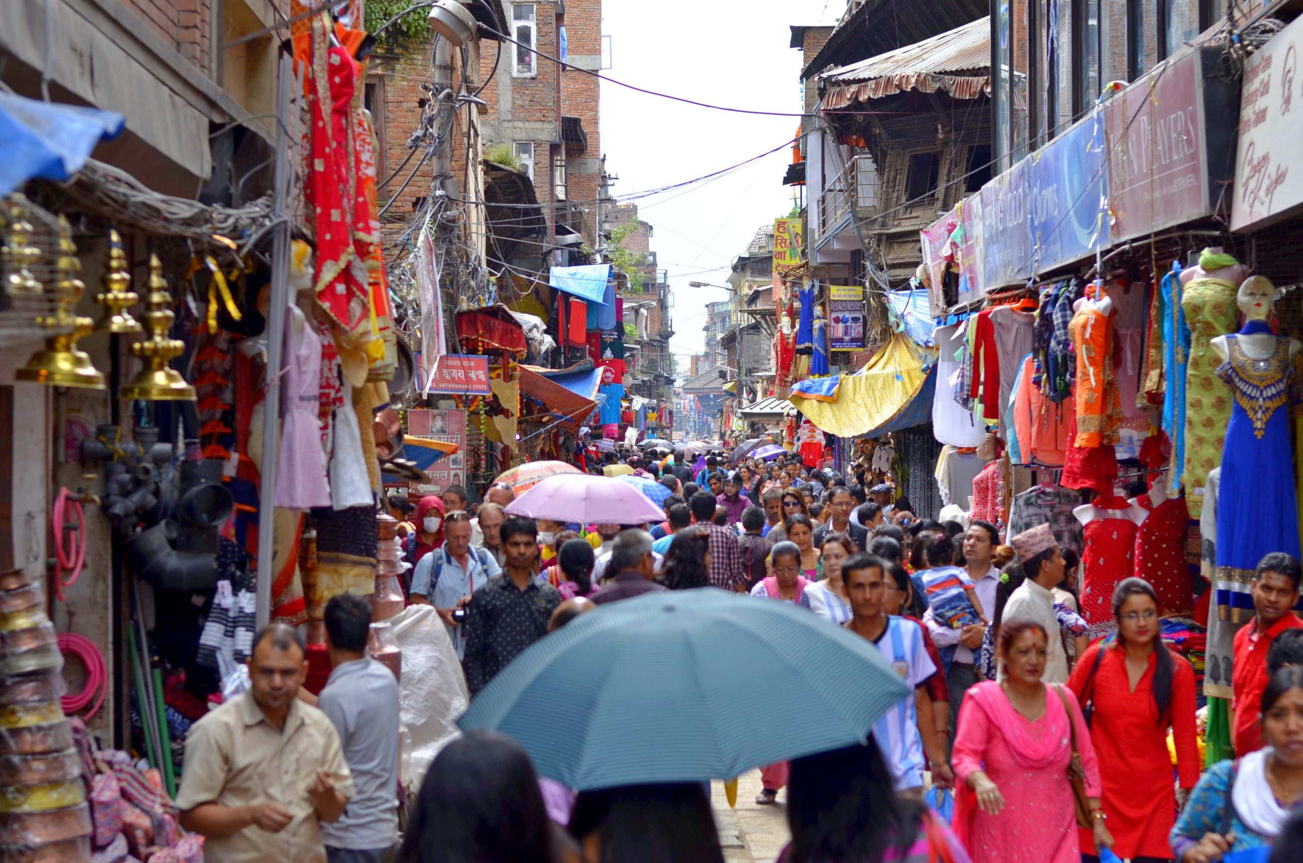 A busy street scene. People walk through a market in Kathmandu, Nepal.